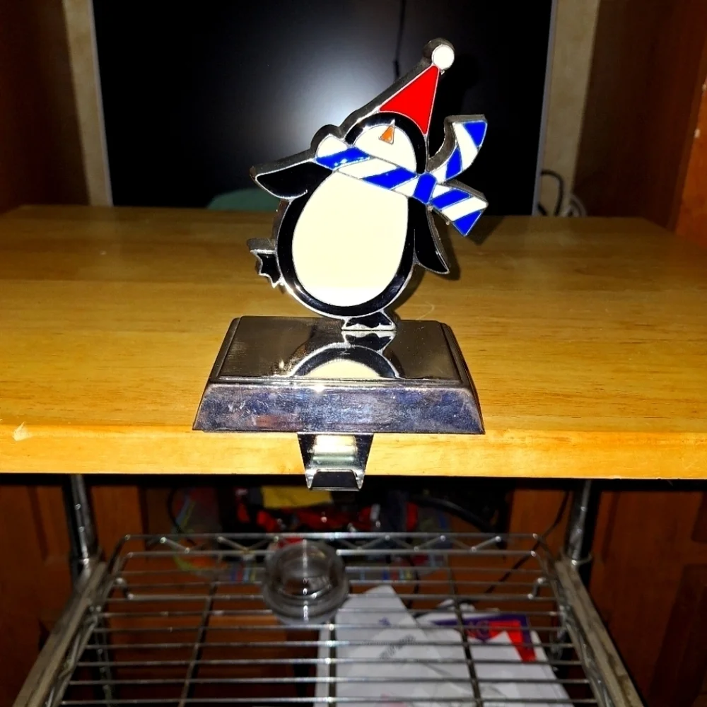 An unbranded Penguin Stocking Holder    It's base is 4